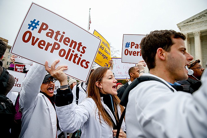 Demonstrators chant during a health care rally in March outside the Supreme Court in Washington. The Supreme Court could wipe away health insurance for millions of Americans when it resolves the latest high court fight over President Barack Obama's health overhaul.