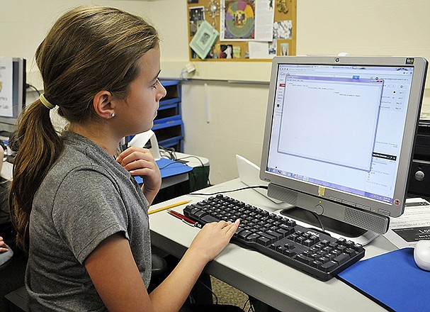 Arica Ketcherside, 10, follows along with the instructor as she types in code for computer programming. She is one of about a dozen students to take part in St. Martins School's first technology summer school class.