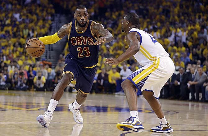 Cleveland Cavaliers forward LeBron James (23) drives against Golden State Warriors forward Harrison Barnes during the first half of Game 1 of basketball's NBA Finals in Oakland, Calif., Thursday, June 4, 2015.