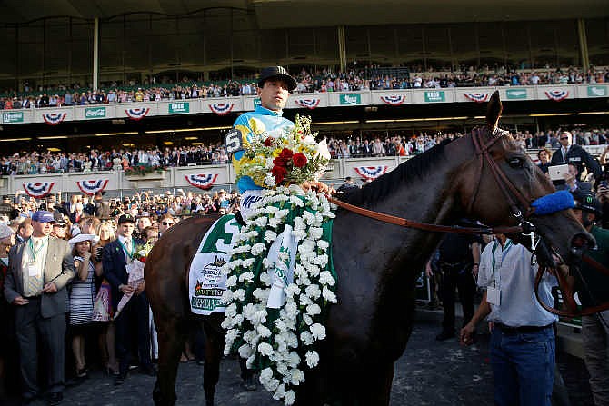 Jockey Victor Espinoza parades American Pharoah through the Winner's Circle after winning the 147th running of the Belmont Stakes horse race at Belmont Park, Saturday, June 6, 2015, in Elmont, N.Y. American Pharoah is the first horse to win the Triple Crown since Affirmed won it in 1978.