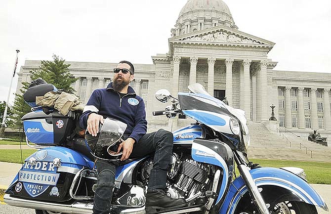 Nate Hudson poses for a photograph Friday during
interviews at the Missouri Capitol. Hudson is a motorcycle rider
and advocate for safety and is riding across the country
spreading awareness for motorcycle safety, sponsored by Allstate Insurance.