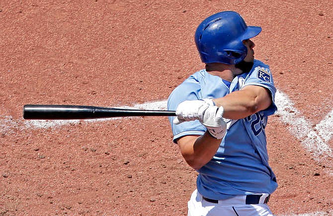 Kansas City Royals' Kendrys Morales hits an RBI-double during the fifth inning of a baseball game against the Texas Rangers, Sunday, June 7, 2015, in Kansas City, Mo.