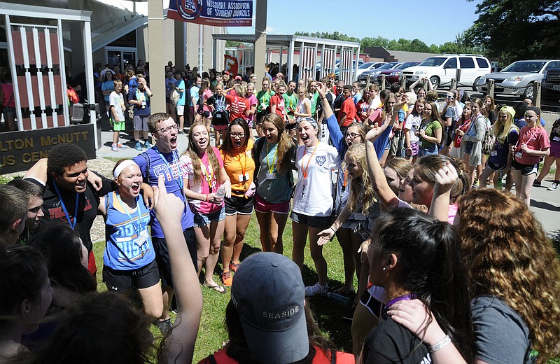Members of Council V, a group of 27 high school students from across the state, cheer in a circle before heading into the McNutt Campus Center at William Woods University on Monday for a pep rally to kick off the Missouri Association of Student Councils' Summer Workshop. 