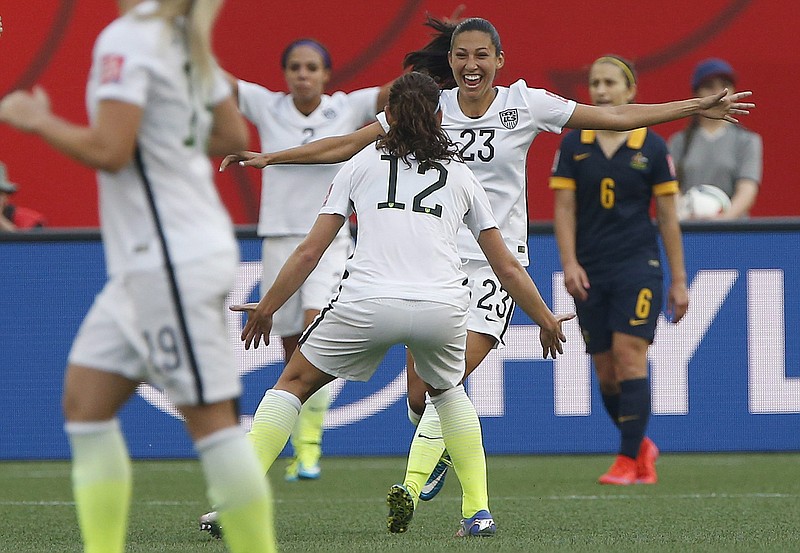 Christen Press (23) celebrates her goal with United States teammate Lauren Holiday (12) during Monday night's match against Australia in Winnipeg, Manitoba.