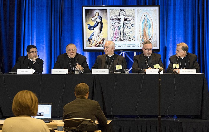 Bishop Oscar CantÃº, left, of Las Cruses; Archbishop Thomas Wenski, of Miami; Archbishop Joseph Kurtz, of Louisville and president of the U.S. Conference of Catholic Bishops; Bishop Christopher Coyne, of Burlington; and Archbishop John Wester, of Santa Fe, participate in a news conference during the U.S. Conference of Catholic Bishops' Spring General Assembly in St. Louis Wednesday.