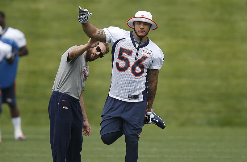 Shane Ray performs an exercise for a Broncos trainer Thursday during minicamp at the team's headquarters in Englewood, Colo.
