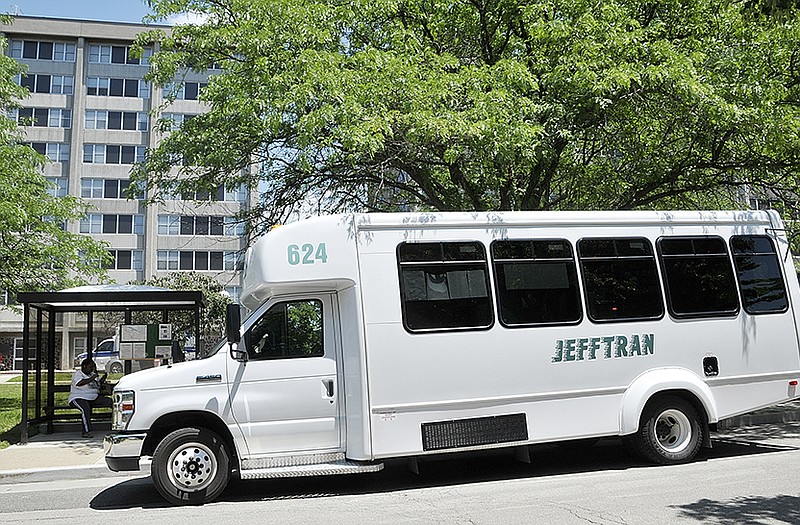 The JeffTran Handi Wheels bus is stopped outside Dulle Hamilton Towers to drop off and pick up riders.