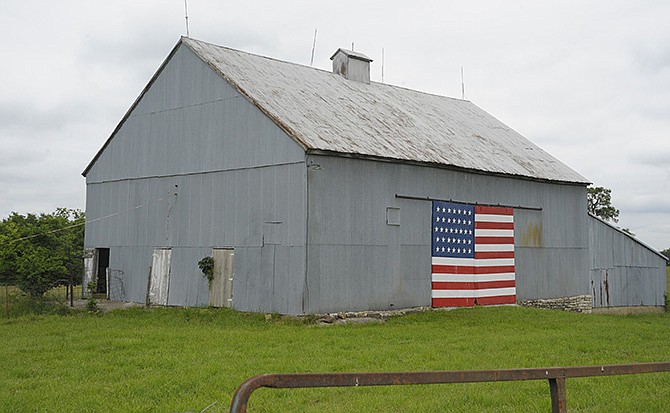 
Brothers Paul and Fred Bloch painted the door of their barn with a 12-by-20-foot flag 10 years ago. The flag was painted with 35 stars rather than 50, showing how many stars were on the flag when the family bought the farm in 1865.