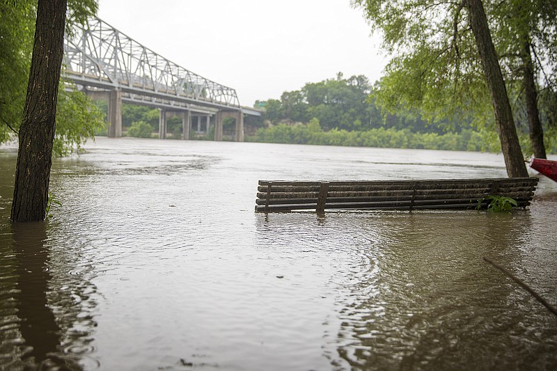 A bench is seen submerged Tuesday at Noren River Access as the Missouri River continues to rise after rainstorms continue for the second week in a row, reaching above 26 feet.  