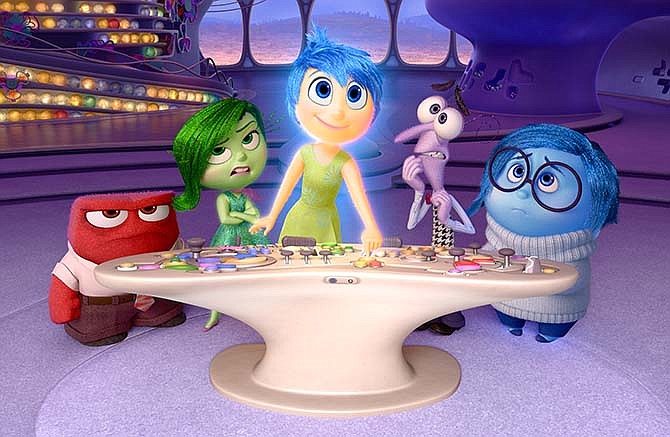 In this file image released by Disney-Pixar, characters, from left, Anger, voiced by Lewis Black, Disgust, voiced by Mindy Kaling, Joy, voiced by Amy Poehler, Fear, voiced by Bill Hader, and Sadness, voiced by Phyllis Smith appear in a scene from "Inside Out." 