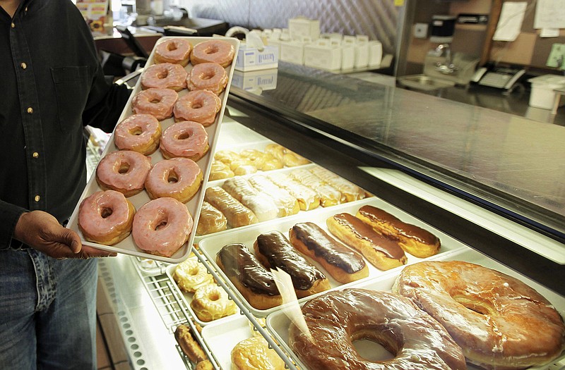 Doughnuts are displayed in Chicago. The Obama administration is cracking down on artificial trans fats, calling them a threat to public health. The Food and Drug Administration said Tuesday that it will require food companies to phase out the use artificial trans fats almost entirely. Consumers aren't likely to notice much of a difference in their favorite foods, but the administration says the move will to reduce coronary heart disease and prevent thousands of fatal heart attacks every year.