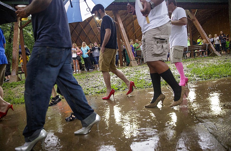 Participants leave the starting line Tuesday during the 14th Annual Walk a Mile in Her Shoes fundraiser hosted by the Jefferson City Rape and Abuse Crisis Service at Memorial Park. Despite rainstorms, about 80-90 participants completed the walk. 