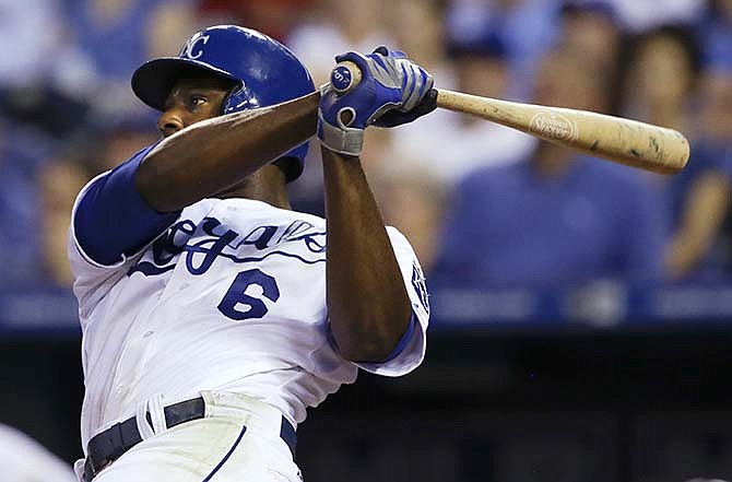 Kansas City Royals' Lorenzo Cain follows through on an RBI triple off Milwaukee Brewers starting pitcher Mike Fiers during the fifth inning of a baseball game at Kauffman Stadium in Kansas City, Mo., Wednesday, June 17, 2015. 