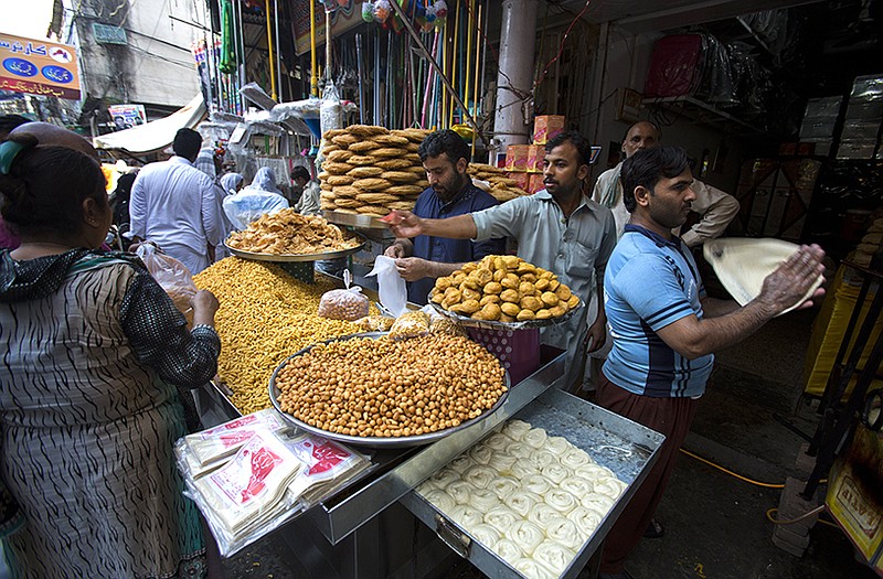 Pakistani customers buy foodstuff ahead of Ramadan in Rawalpindi, Peshawar, Pakistan.  Muslims throughout the world mark the month of Ramadan, the holiest month in the Islamic calendar, with dawn to dusk fasting.