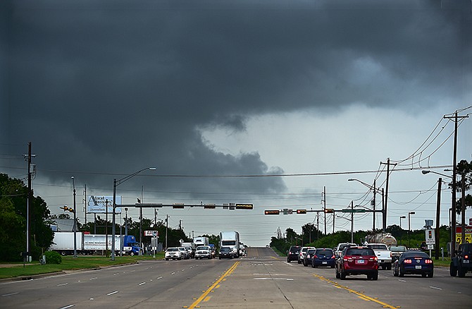 Ominous low-hanging clouds accompanied a thunderstorm from the outer bands of Tropical Storm Bill that was already reaching North Texas as this cell passed over East University Drive Tuesday in Denton, Texas. 