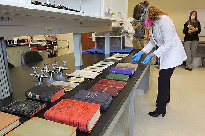 The contents of the Capitol's 100-year-old time capsule were removed Thursday by conservators from the Missouri State Archives.