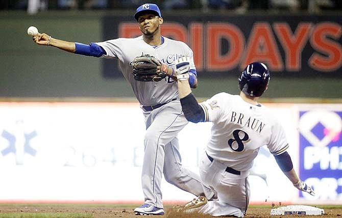 Milwaukee Brewers' Ryan Braun is out at second as Kansas City Royals' Alcides Escobar turns a double play on a ball hit by Adam Lind during the first inning of a baseball game Monday, June 15, 2015, in Milwaukee. 