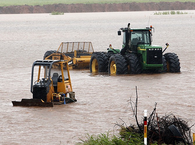 Construction equipment sits in high water from overnight rains off Interstate 35 on Thursday in Pauls Valley, Oklahoma. Tropical Depression Bill swamped Oklahoma and Arkansas on Thursday, pushing rivers toward record levels after the Gulf-fueled storm slowed to a crawl over the nation's midsection. 
