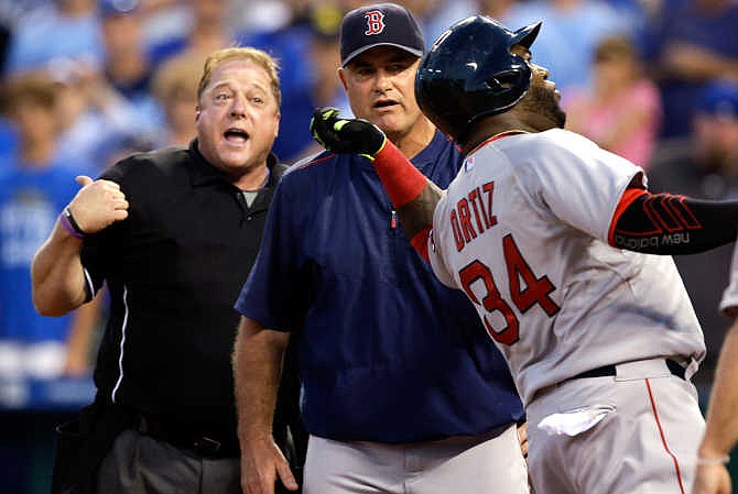 Boston Red Sox designated hitter David Ortiz (34) acts as if he's throwing home plate umpire Bruce Dreckman, left, out of the baseball game during the seventh inning against the Kansas City Royals at Kauffman Stadium in Kansas City, Mo., Saturday, June 20, 2015. Ortiz was ejected from the game after arguing a call.Red Sox manager John Farrell stands between the two. 