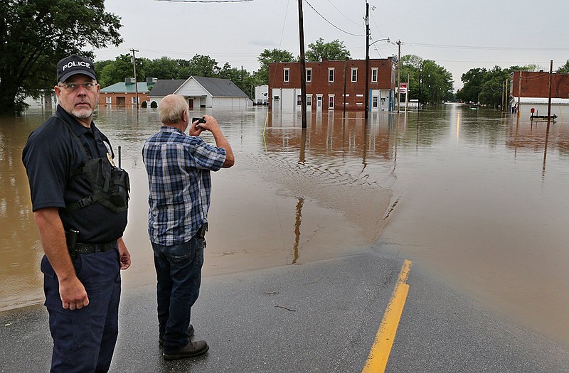 
Silex police officer Joe Garagnani and Silex Mayor David Rice look at their town, flooded by the Cuivre River in Lincoln County.