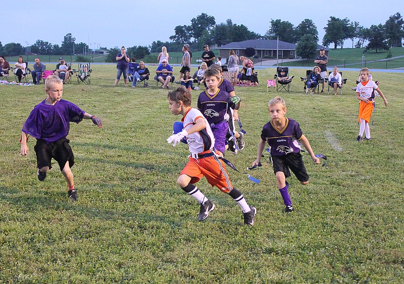 Noah Steenbergen runs to the left side during Russellville's flag football game Friday, June 19.