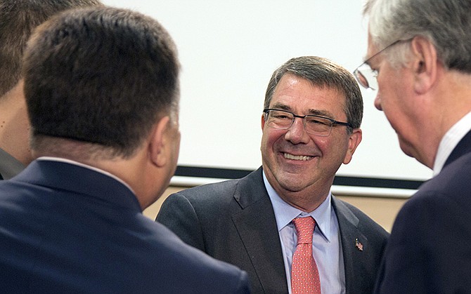 Ukraine's Defense Minister Stepan Poltorak, left, speaks with United States Defense Minister Ashton Carter, center, during a meeting of the NATO-Ukraine Commission at NATO headquarters in Brussels on Thursday. NATO defense ministers meet for a second day of sessions to discuss, among other issues, the situation in Ukraine.