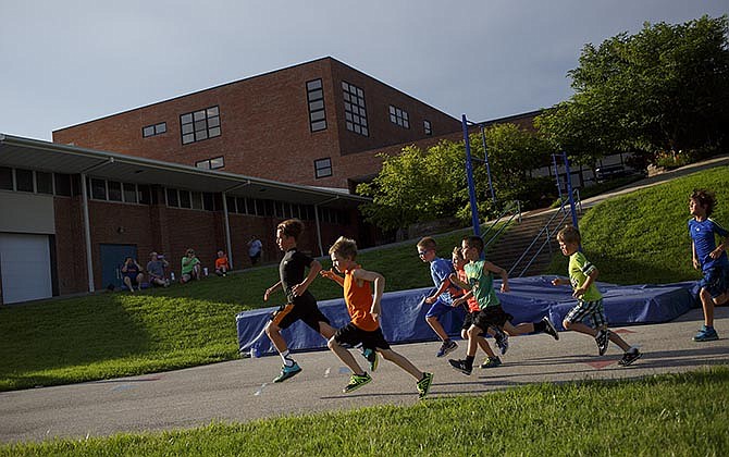Members
of the boys 800-
meter run head
into the first
turn. The youth
meet is held
every Tuesday
and Thursday in
June, and the
final installment
for this season
will be held Tuesday.
