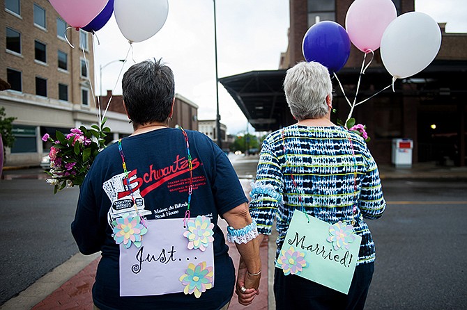 Barb Sonderman, left, and her partner of 17 years Martha Pickens walk together as a married couple for the first time after the Supreme Court's ruling that same-sex couples have the right to marry in all 50 states on Friday outside the Boone County Courthouse in Columbia.