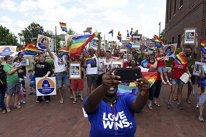 Takya Browning, president of Augusta Pride, takes a selfie with gay marriage supporters during a rally at the John H. Ruffin, Jr., Courthouse in Augusta, Georgia, on Friday. 