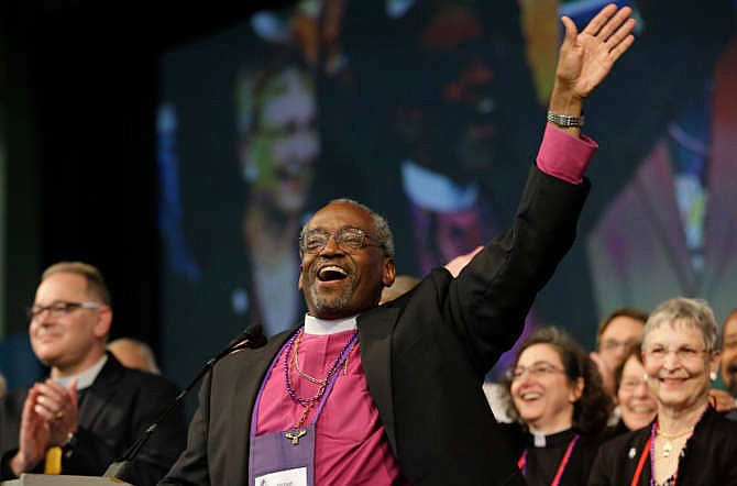 Bishop Michael Curry, of North Carolina, waves to the crowd after being elected the Episcopal Church's first African-American presiding bishop at the Episcopal General Convention Saturday, June 27, 2015, in Salt Lake City. Curry won the vote in a landslide. 