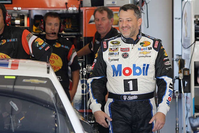 Tony Stewart walks to his car during practice for the NASCAR Sprint Cup Series auto race Friday, June 26, 2015, in Sonoma, Calif. 