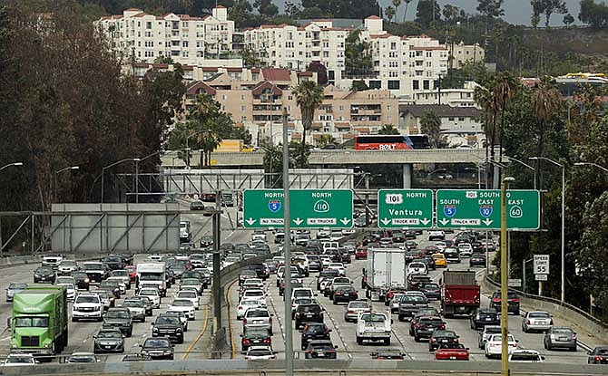 In this Wednesday, May 6, 2015 photo, traffic slowly moves along the 110 Freeway during afternoon rush hour in downtown Los Angeles. Within 30 years, the Department of Transportation projects, drivers will have to tolerate stop-and-go conditions or slow traffic for some period of each day on more than a third of U.S. highways. 