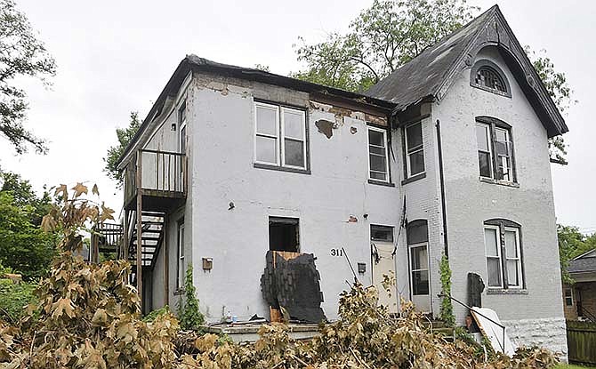 This residence at 311 Cherry St. has been purchased
and the new owner has started cleaning up the property.
He plans to selectively demolish the structure to get
to the original building. There are a number of abandoned
properties in Jefferson City in need of demolition
or major repairs.