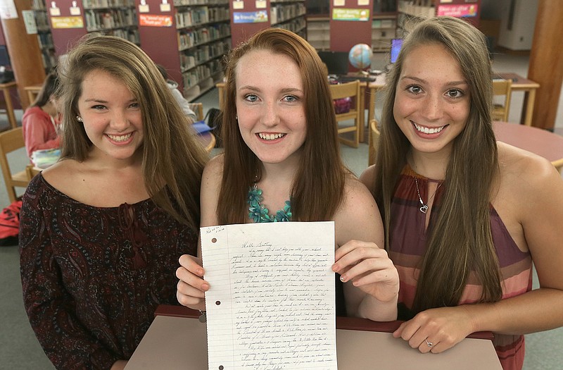 From the left, high school students Mollykate Rodenbush, Brittany Tainsh, and Michaela Arguin, hold a letter from former Boston crime boss James "Whitey" Bulger.