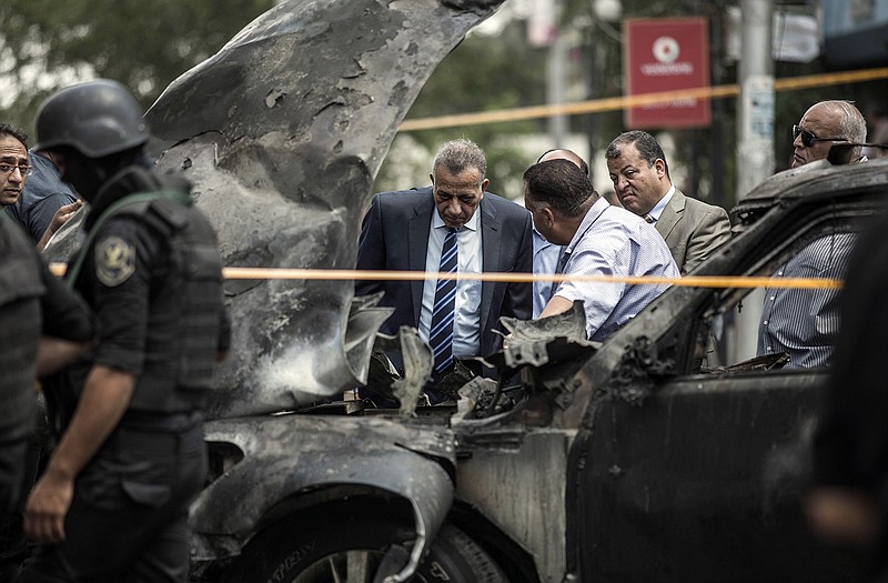 Security personnel investigate the site of a bombing that killed Egypt's top prosecutor, Hisham Barakat, in Cairo, Egypt, on Monday. The car bomb killed Barakat, in the first assassination of a top official in the country in a quarter century, marking an apparent escalation by Islamic militants in their campaign of revenge attacks for a 2-year-old crackdown on the Muslim Brotherhood. 