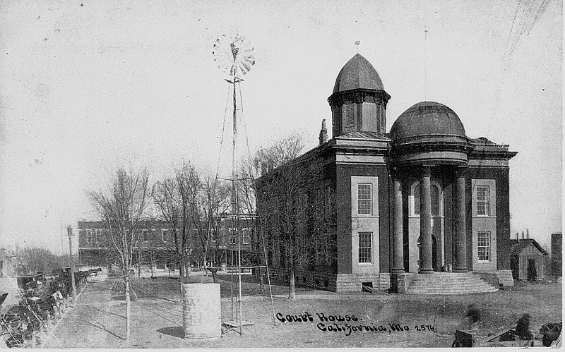 This early postcard shows the Moniteau County Courthouse with a windmill on the lawn.