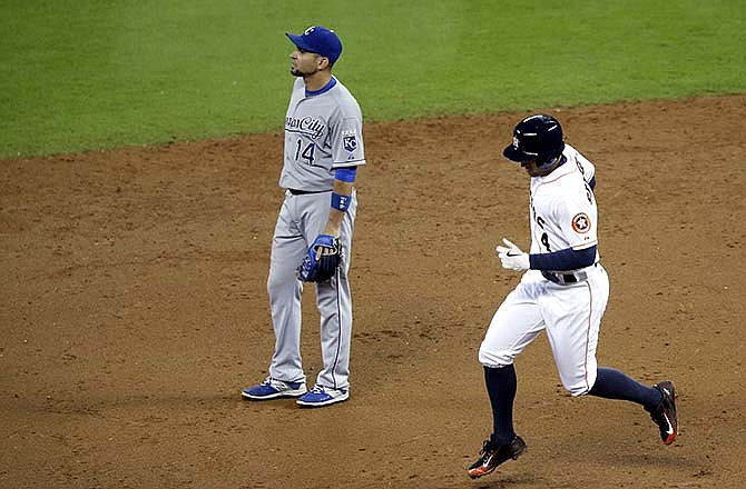 Houston Astros' George Springer (4) rounds the bases as Kansas City Royals second baseman Omar Infante (14) looks to the outfield on a two-run homer in the third inning of a baseball game Tuesday, June 30, 2015, in Houston.