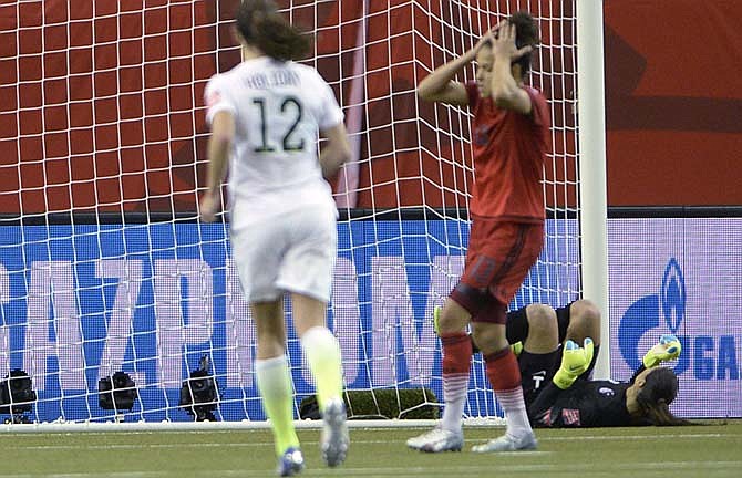 Germany's Celia Sasic (13) reacts after missing a penalty kick against U.S. keeper Hope Solo during the second half of a semifinal in the Women's World Cup soccer tournament, Tuesday, June 30, 2015, in Montreal, Canada. (Ryan Remiorz/The Canadian Press via AP)