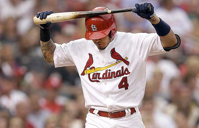 St. Louis Cardinals' Yadier Molina walks back to the dugout after striking out during the second inning of a baseball game against the Chicago White Sox on Tuesday, June 30, 2015, in St. Louis.