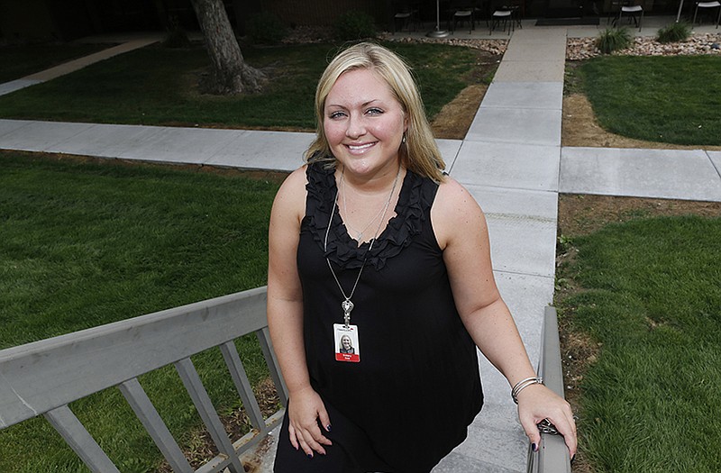  Brittany Swa poses for photos near the office of her new employer in Greenwood Village, Colo. Swa, a former manager of a Chipotle restaurant in Denver, has joined a class-action lawsuit against her former employer, which charges that apprentices shouldn't be classified as managers exempt from overtime. 