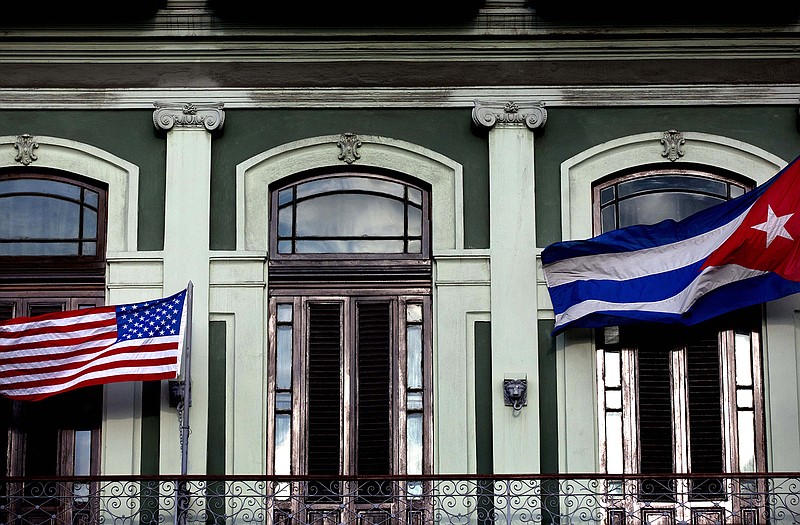 Cuban and American flags wave from the balcony of the Hotel Saratoga in Havana. 