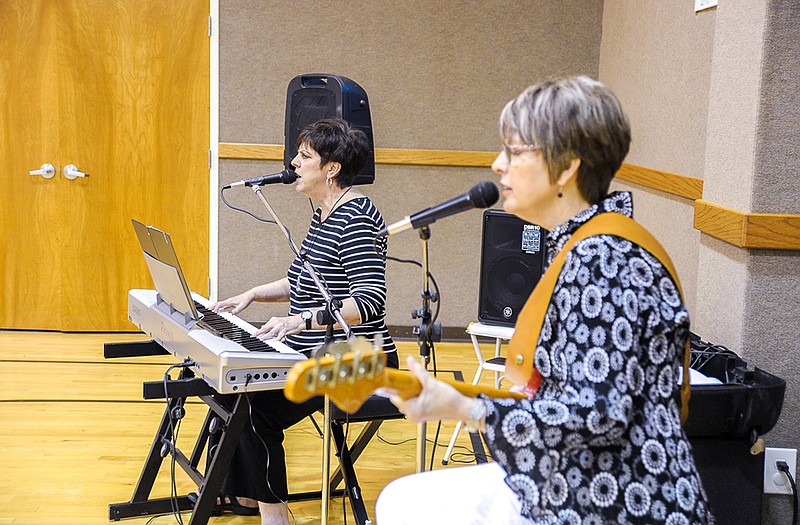 Sisters Connie Walker and Linda Cable provided musical entertainment while guests enjoyed ice cream sundaes prior to a Friends of the Library Family Feud fundraiser.