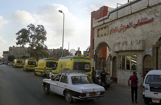 Ambulances wait in front of the El Arish International Hospital Wednesday because the road to Sheikh Zuweid, where numerous assaults against the army were ongoing, was not safe, in El Arish, north Sinai, Egypt.