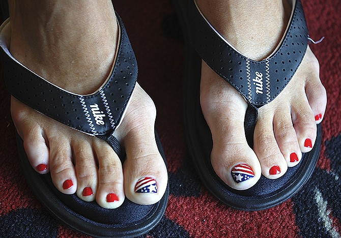 A customer gets a patriotic-themed pedicure by Kim Nocula at Kim's Nail Salon on Missouri Boulevard. 