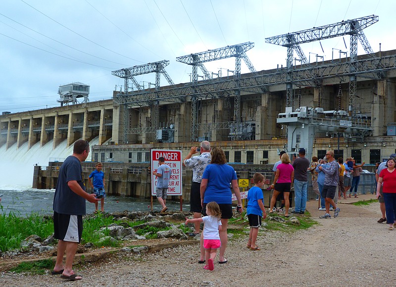 Crowds of tourists spent part of Thursday morning, July 2, bumping shoulders in an effort to snap a close up of the millions of gallons of water spilling from Bagnell Dam's open floodgates.