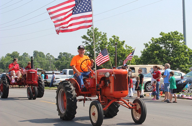 The tractor portion of Eldon's 2013 Indpendence Day parade makes its way down Mill Street.