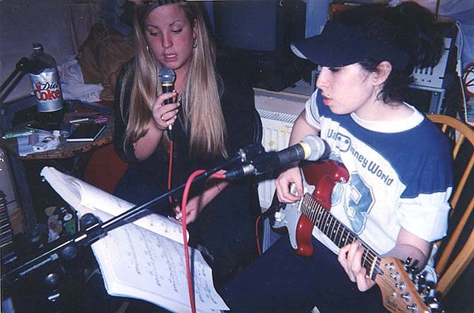 In this image released by A24 Films, singer Amy Winehouse, right, appears in a scene from the film, "Amy."