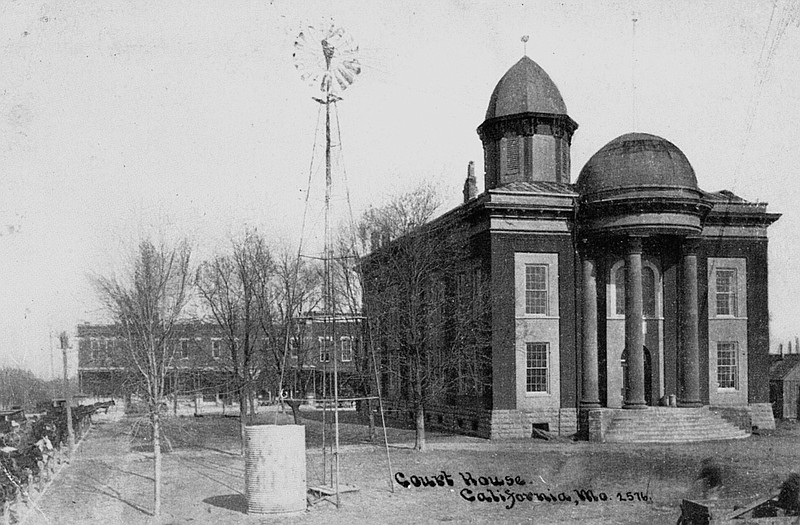 This early postcard shows the Moniteau County Courthouse with a windmill on the lawn.
