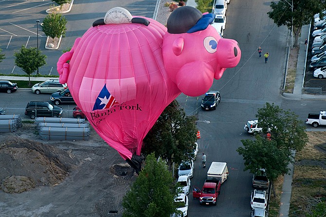 The Bank of American Fork piggy bank balloon crash lands near Utah Valley Regional Medical Center during America's Freedom Festival Balloon Fest on Thursday.