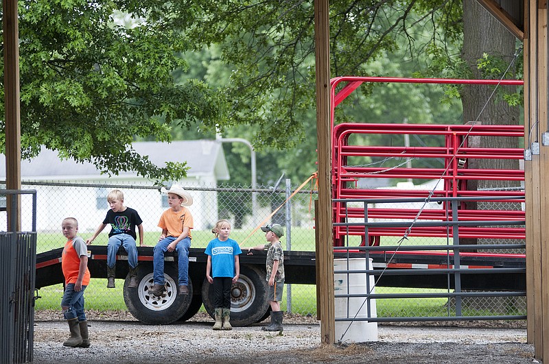 Children wait for their chance to help set up the Auxvasse Lion's Club grounds on Thursday in preparation for the Callaway County Youth Expo, which will be July 7-11.